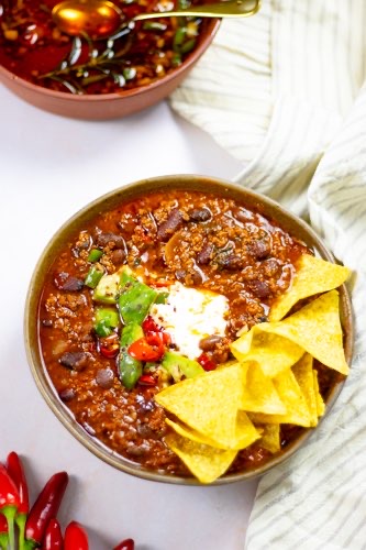 chili con carne recipe full of flavor and chili oil on side