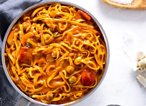 A pan with the most creamy tomato coconut fettuccine